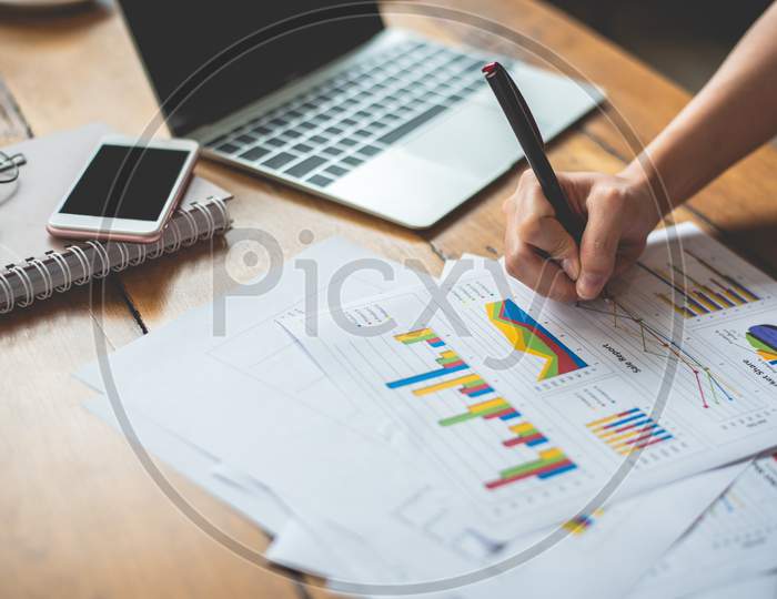 Close Up Of Businesswoman Hand Writing Summary Report Data. Marketing And Business Ownership Concept. People And Lifestyles Concept. Business Employee And Financial Theme.