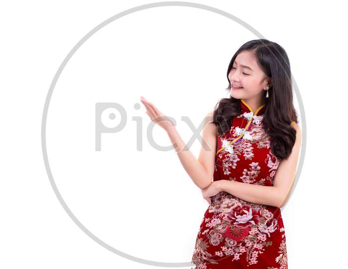 Young Asian Beauty Woman Wearing Cheongsam And Presenting With Hands Gesture In Chinese New Year Festival Event On Isolated White Background. Holiday And Lifestyle Concept. Qipao Dress Wearing
