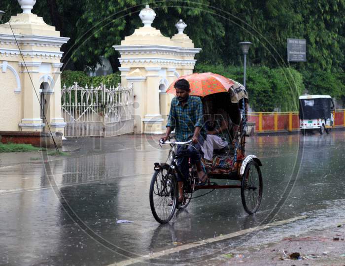 A Man Peddles a Rickshaw During a Heavy Pre Monsoon Rain In Prayagraj, June18, 2020.