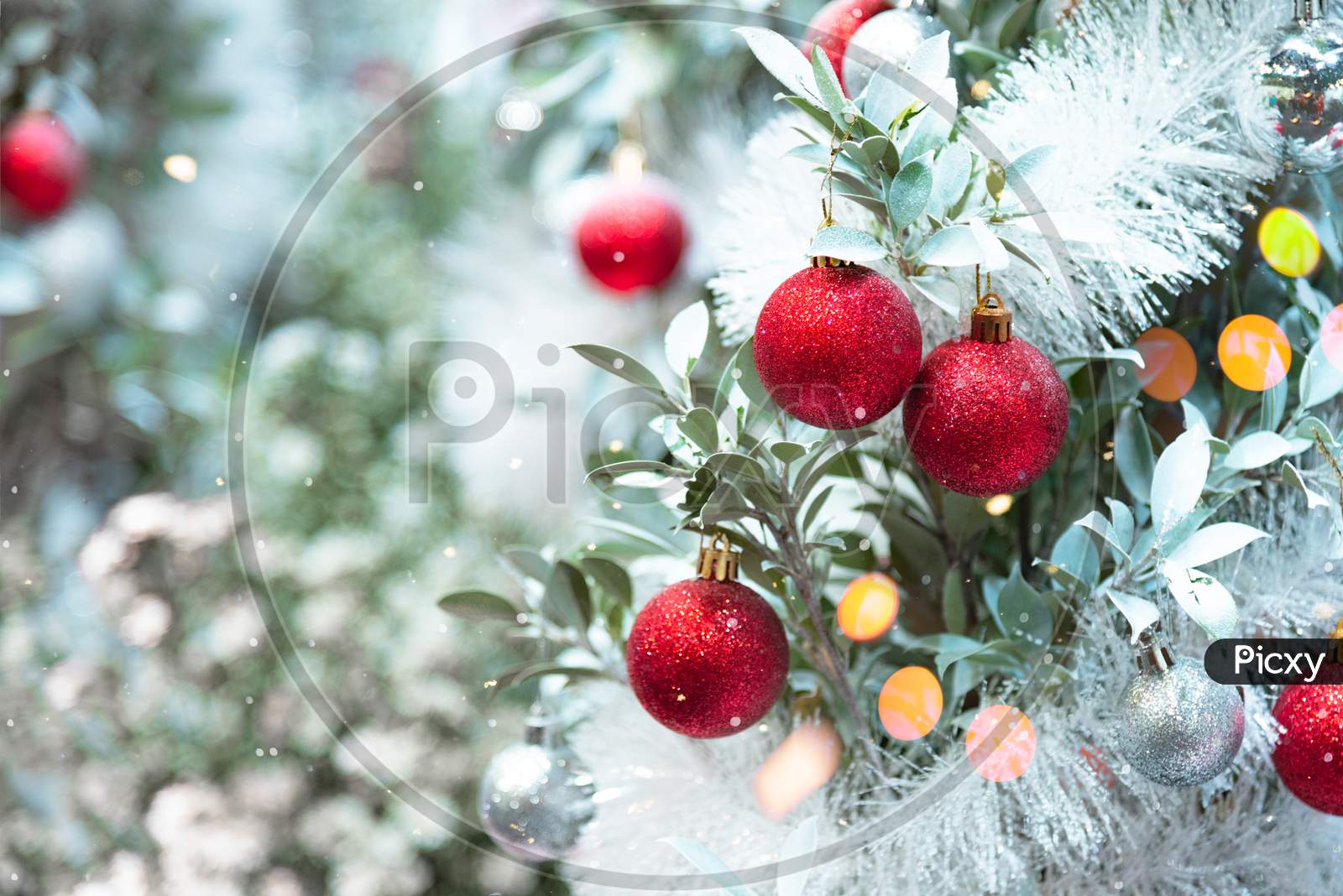 Christmas Ornaments Decorating On Christmas Snowy Tree. Merry Xmas And Happy New Year Concept Background.