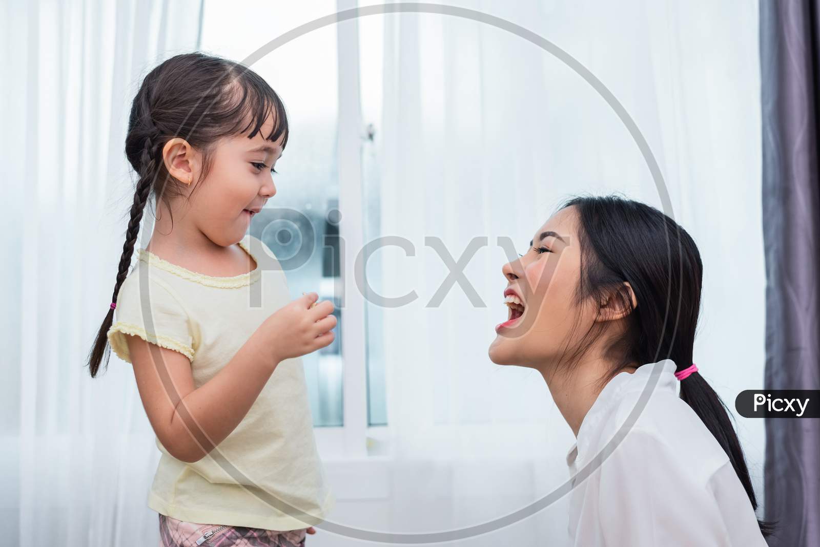 Daughter Feeding Mom With Potato Chip Funny. Back To School And Education Concept. Children And Kids Theme. Home Sweet Home And Nursery Theme.