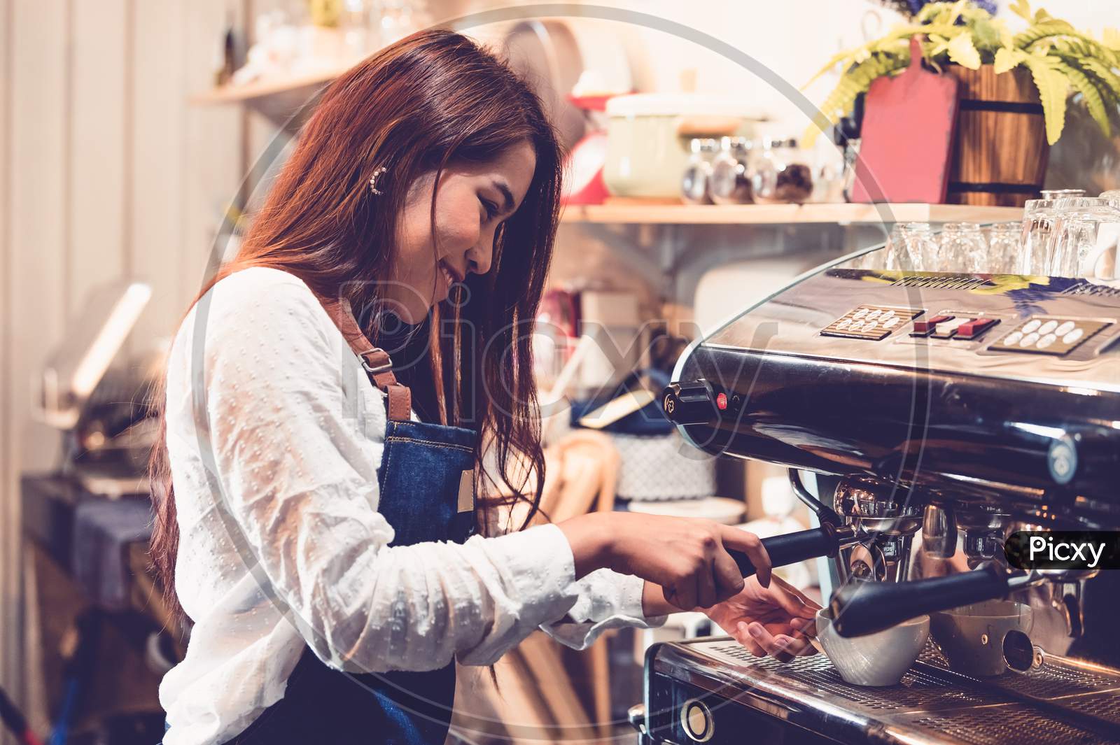 Professional Female Barista Hand Making Cup Of Coffee With Coffee Maker Machine In Restaurant Pub Or Coffee Shop. People And Lifestyles. Business Food And Drink Concept.  Happy Shop Owner Entrepreneur