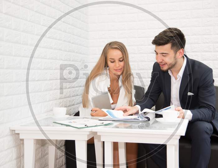 Business Man And His Secretary Talking For Annual Report Of Year And Profit. Teamwork Meeting And Consulting Concept. Cooperation And Office Theme. Man And Woman Talking About Presentation Report