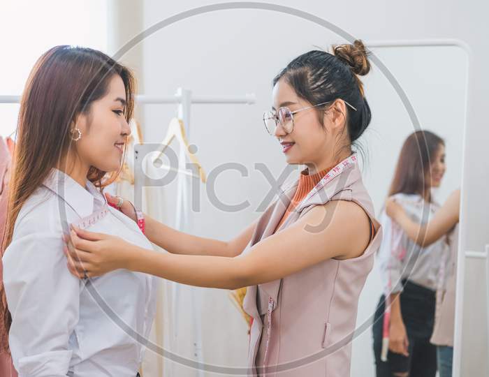 Dressmaker Measuring Female Customer Shoulder And Chest In Sewing Atelier Workshop Office. Tailor And Fashion Designer Concept. Job And Freelance Occupation. Business People In Clothing Shop