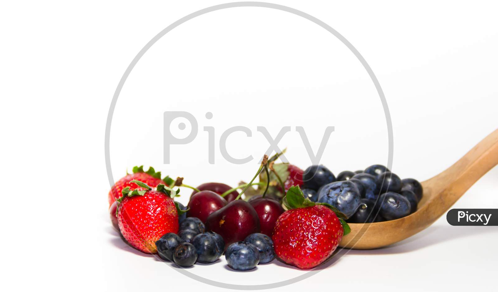 Red Fruits On White Background And Wooden Spoon