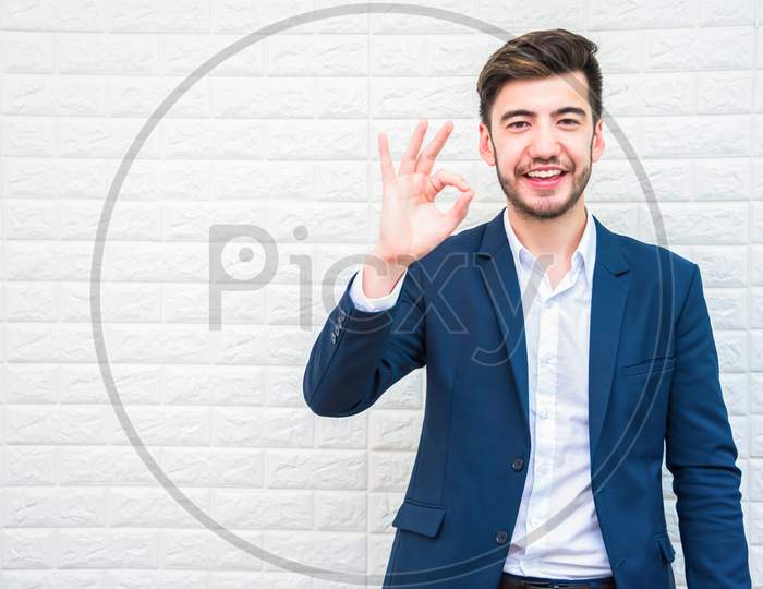 Handsome Businessman Doing Okay Or Alright Gesture. Business And Success Concept. People And Portrait Theme.