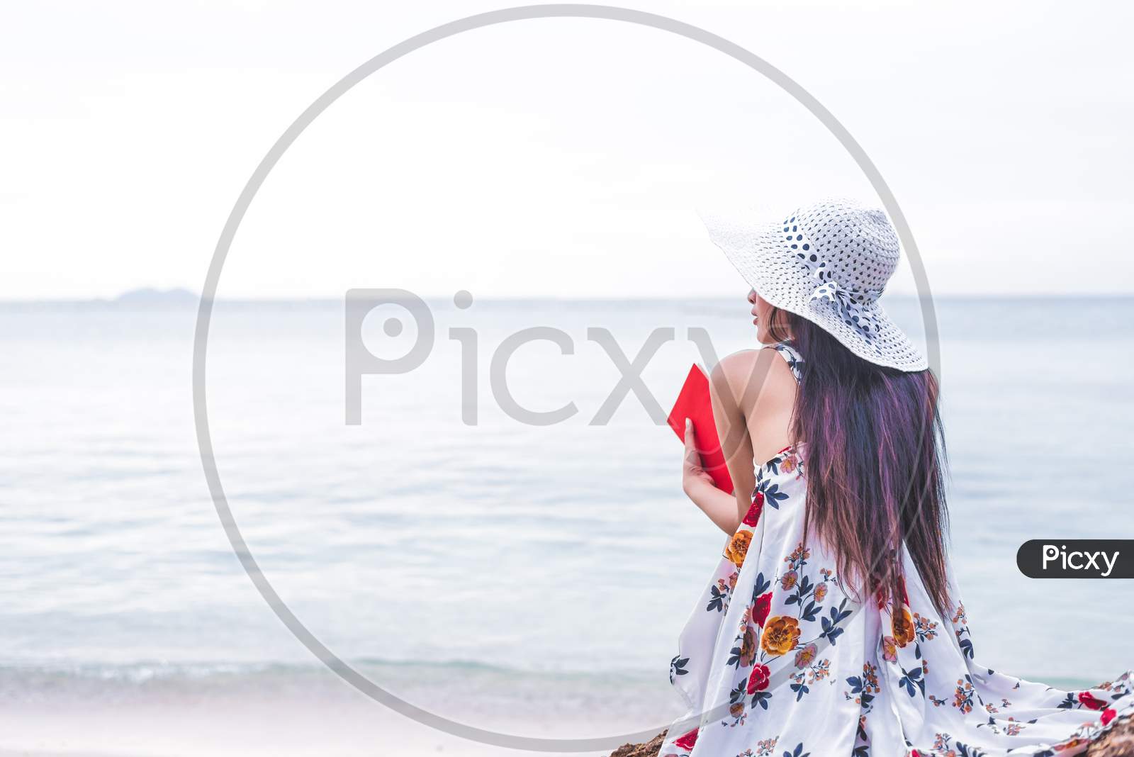 Asian Woman Waiting For Love Or Someone Make Her Happy. Lonely And Beauty Concept. Back View Scene Of Girl. Ocean And Sea Theme. Copy Space In Left Side. Woman Day And Soulmate Theme.