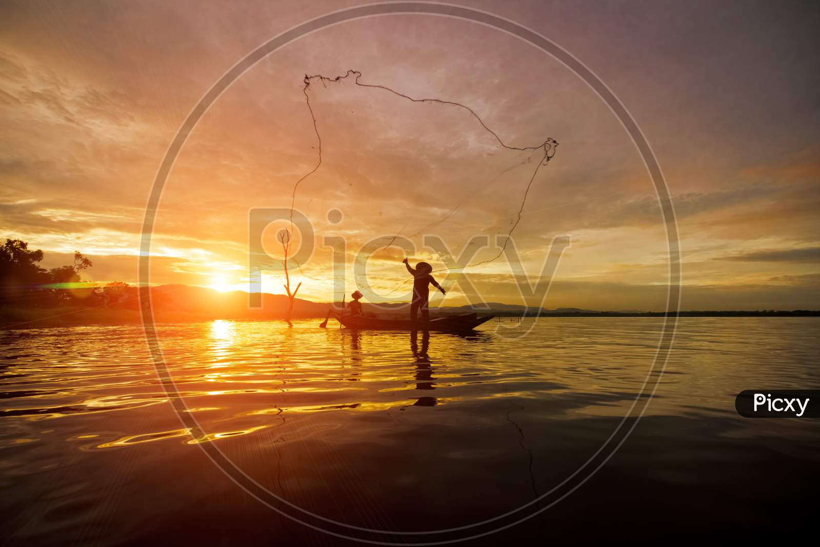 Silhouette Fisherman Fishing By Using Net On The Boat With Sunshine In Thailand In The Morning ,Nature And Culture Concept
