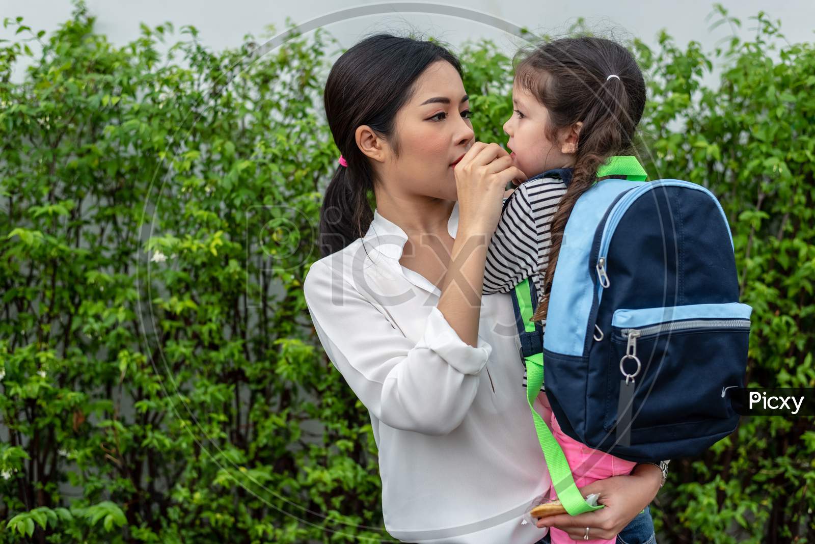 Mom Feeding Her Daughter With Snack Before Going To School. Back To School And Education Concept. Home Sweet Home And Happy Family Theme.