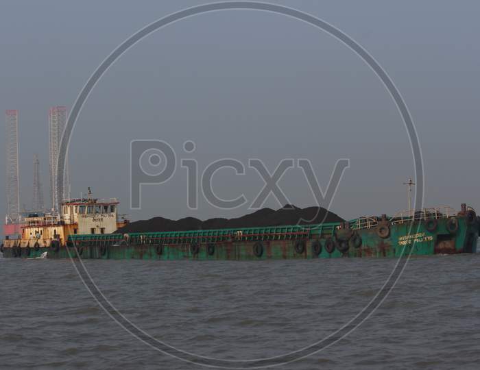 Coal transport ship on Mumbai shore