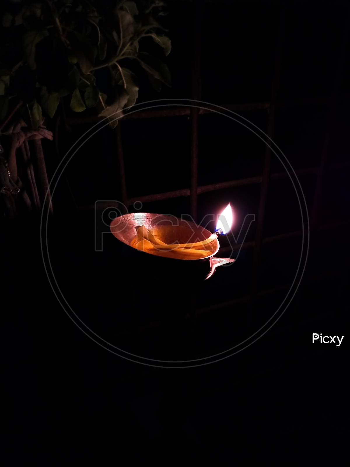 lighting diya under tulsi