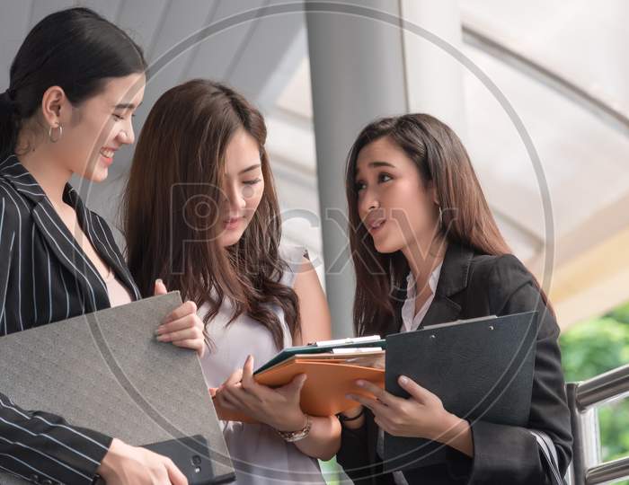 Businesswomen Discussing Monthly Report Meeting Conference. Group Of Business People Sharing Planning Working Experience At Outside Office. Secretary Having Conversation Gossip About Boss Or Coworkers