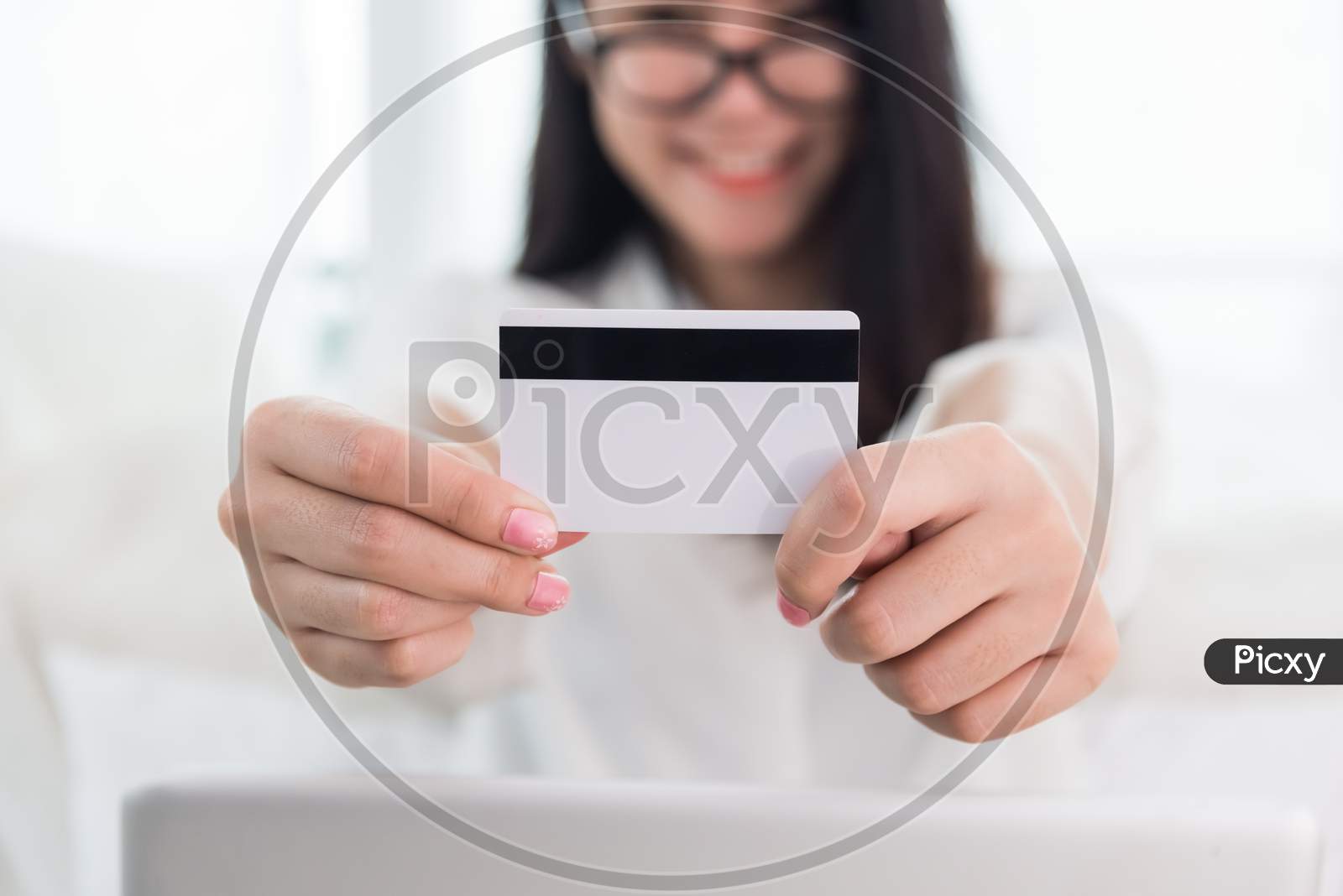 Young Asian Woman Use Credit Card For Online Shopping With Laptop. Business And Banking Payment Concept. Price Sale And Promotion Concept. Technology And Computer Theme. E-Commerce And Marketing Theme