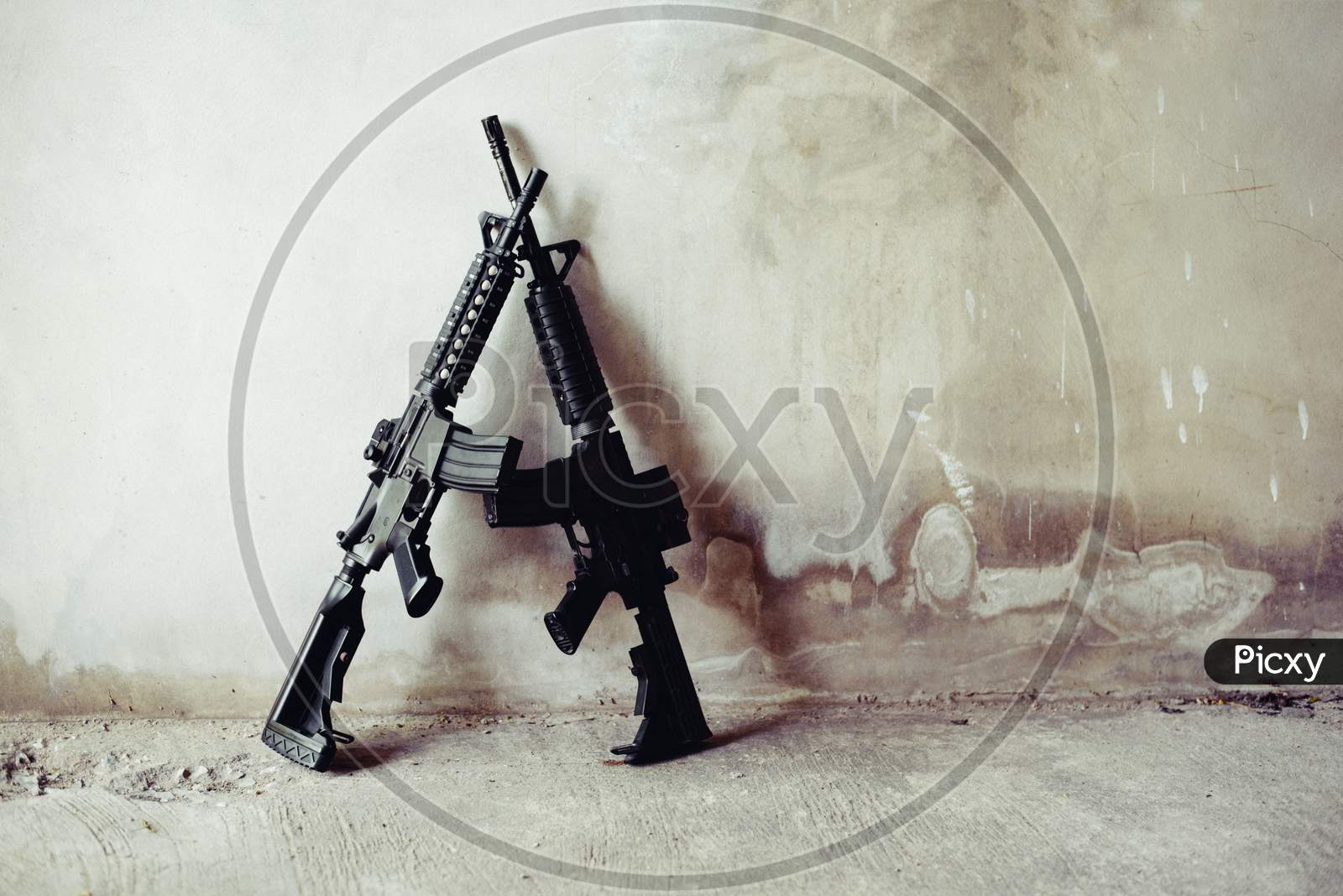 Rifle Guns On Grunge Wall In Abandoned House. Terrorist And Soldier Concept. Robber And Police Concept. War Machine Gun Theme.