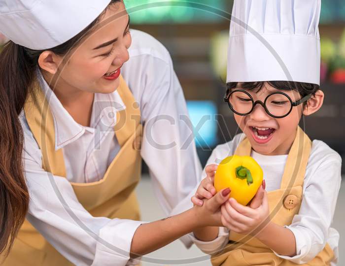 Portrait Cute Little Asian Happy Boy Chef Interested In Cooking With Mother Funny In Home Kitchen. People Lifestyles And Family. Homemade Food And Ingredient Concept. Baking Christmas Cake And Cookies