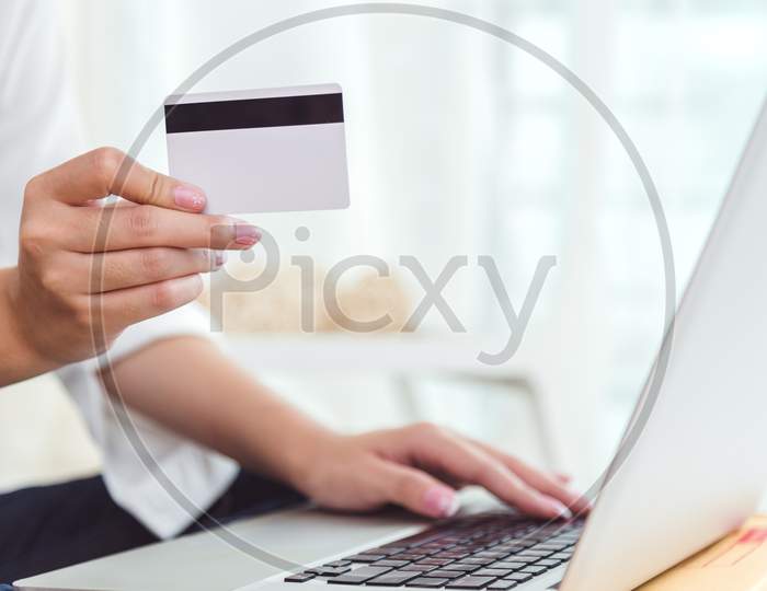 Woman Hands Holding Credit Card For Online Shopping Or Ordering Product From Internet When Using Laptop. Business And Payment Concept. E-Commerce And Internet Security Concept. Home Office And Relax