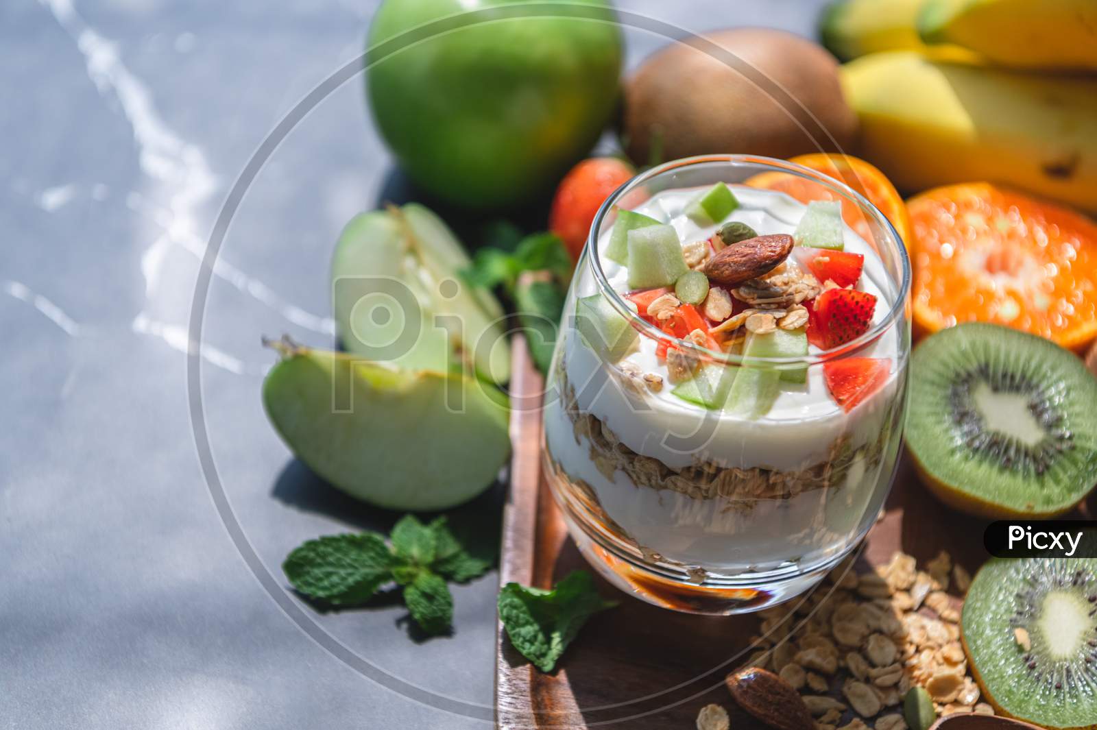 Closeup Nutrition Yogurt With Many Fruits On Table. Food Cuisine And Drinks Concept. Organic Dessert Theme.