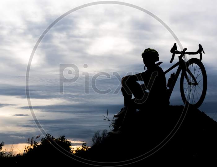 Silhouette Bicycle Cycling Man On The Hill. Relax And Sport Concept