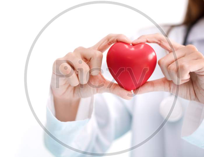 Close Up Of Female Doctor With Red Heart. Medical And Healthcare Concept