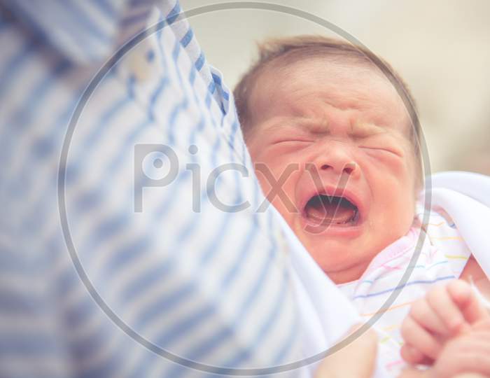 Baby Crying In Mother Embrace. Newborn And Infant Healthy Concept. Birthday And Love Of Mother Theme.