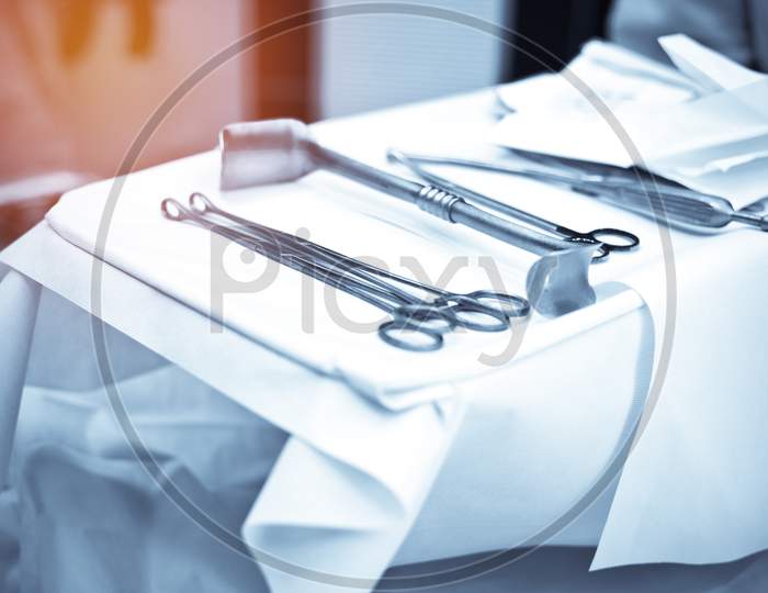 Surgery Instrument And Tools Set On White Sterile Fabric In Operating Room At Hospital. Medical And Healthcare Concept. Emergency And Life Rescue Concept. Operation Room Theme.
