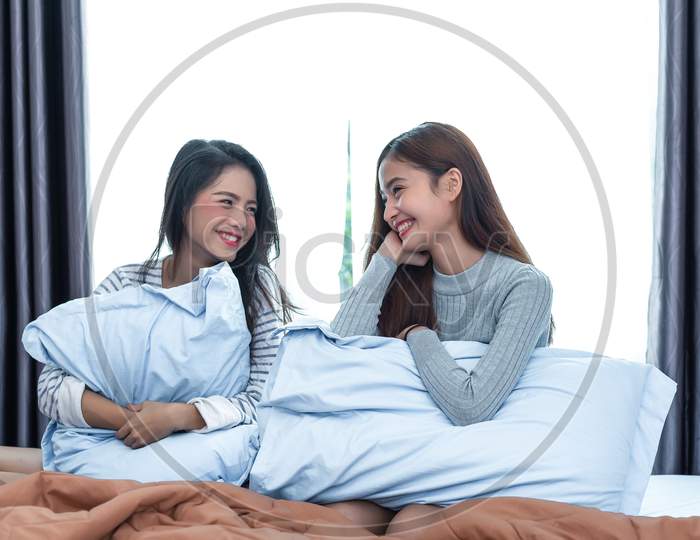 Two Asian Lesbian Looking Together In Bedroom.Beauty Concept. Happy Lifestyles And Home Sweet Home Theme. Cushion Pillow Element And Window Background.