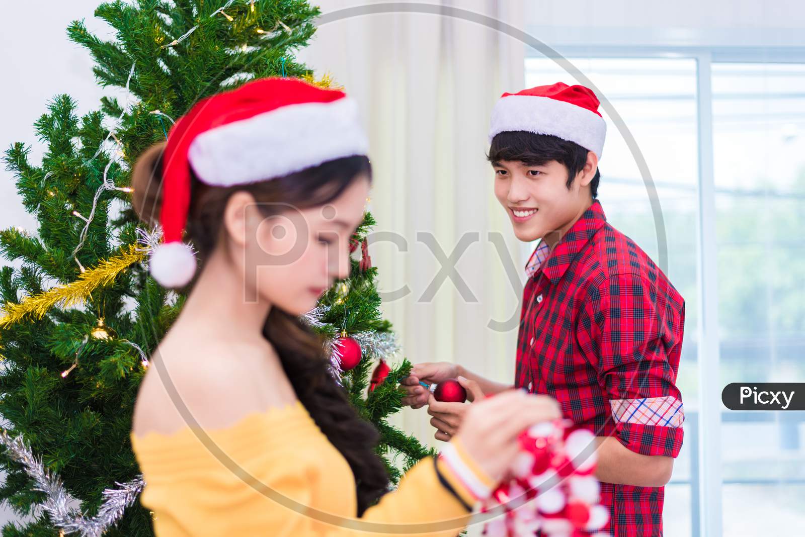First Impression Of Man To Woman Who Prepare To Decorating Christmas Tree In New Year Festival. Xmas And Event Concept. Love Of Lovers And Couples Concept. Bed Room And Living Room Theme. Fall In Love