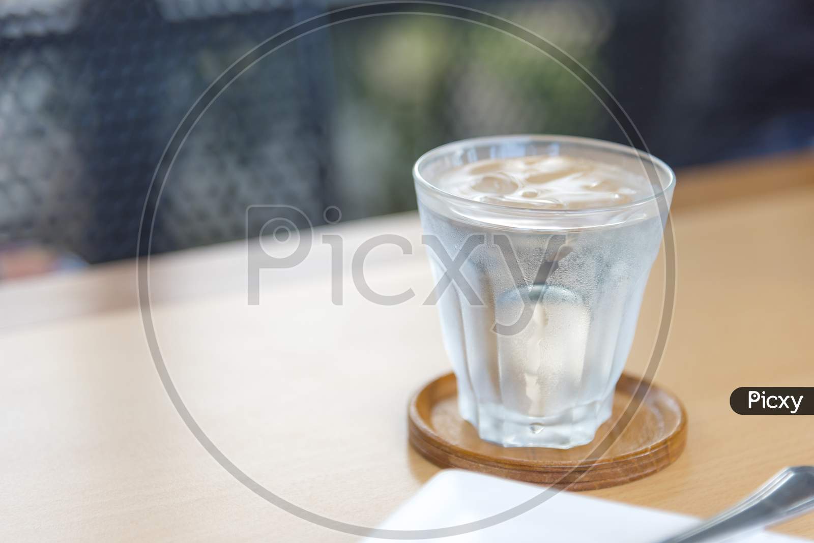 Mineral Water In Glass On Wood Table With Abstract Background, Selective Focus On Stream, Food Drinks And Healthcare Concept