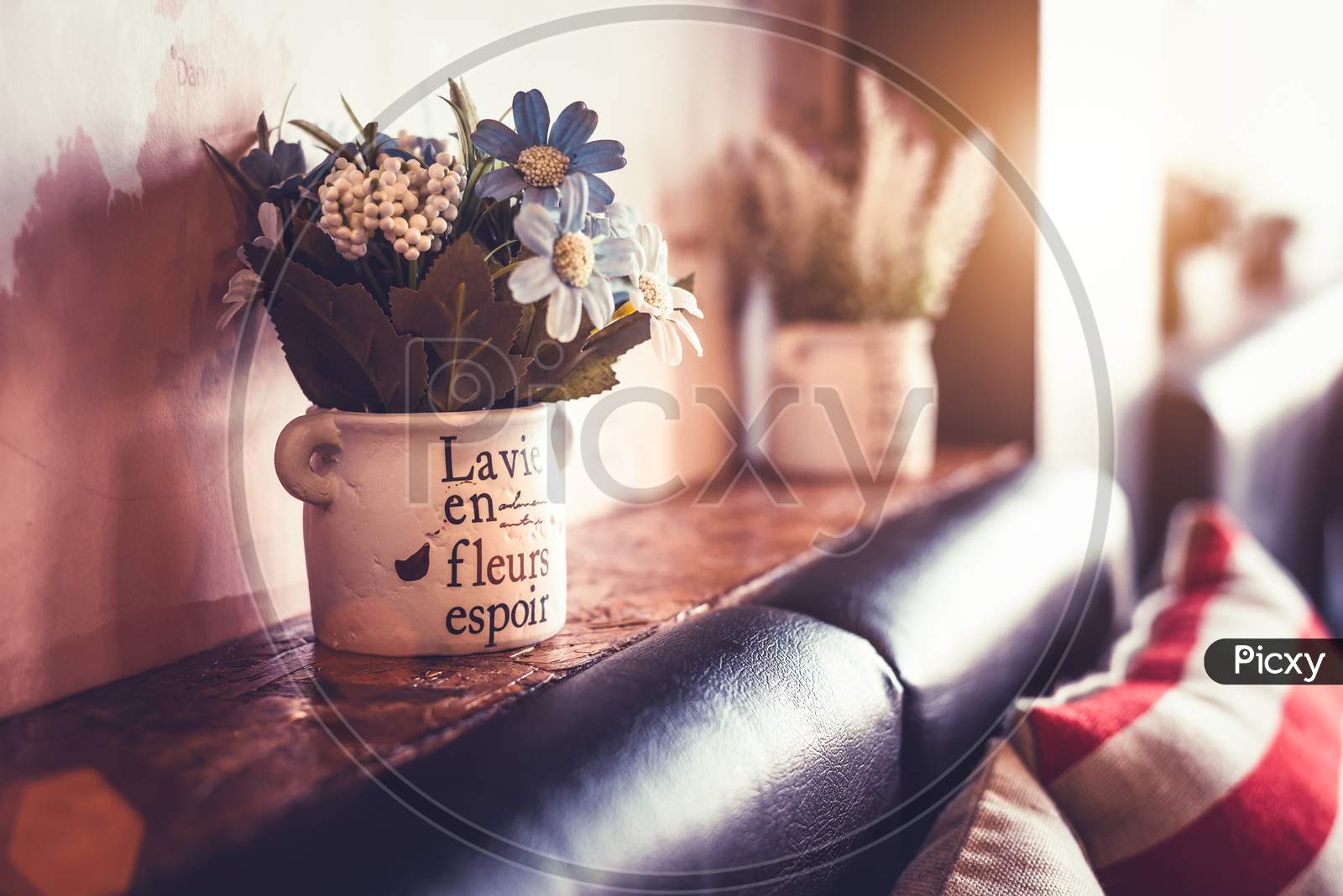 Flower Vase With Sofa And Pillow In Coffee Shop And Restaurant. Gardening Decoration And Interior Concept. Vintage Warm Tone Film.