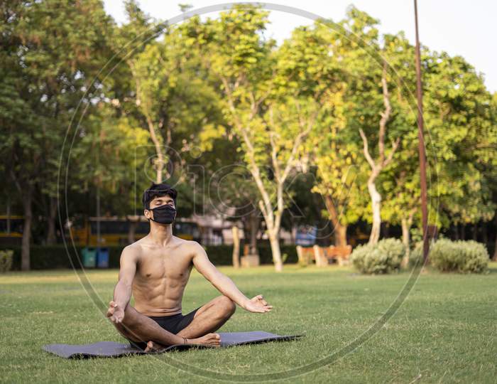 A Young Indian Shredded Teenage Boy Doing Yoga Aasan In The Park On International Yoga Day