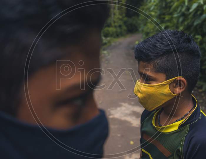 portrait of two boys wearing mask.