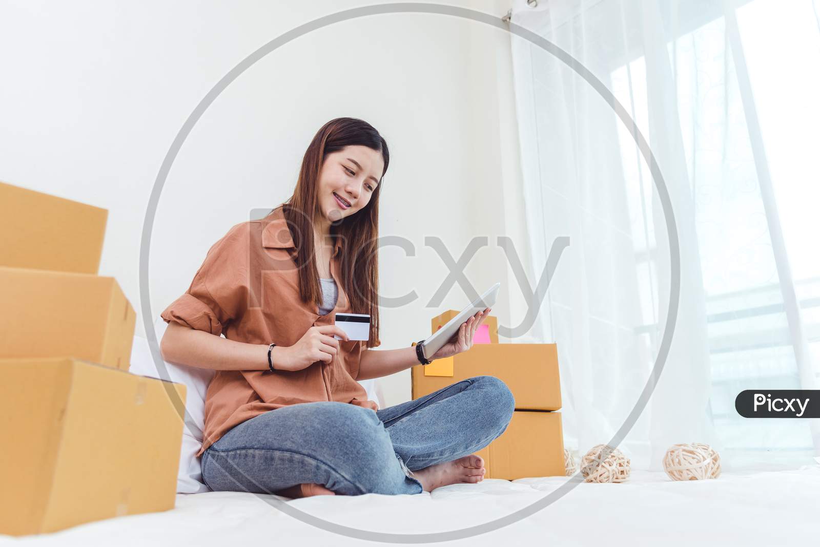 Beauty Asian Woman Using Tablet And Credit Card. Start Up Small Business Entrepreneur Sme And Checking Order List In Bedroom, Young Happy Freelance Woman Shopping Online Marketing Or Sending Parcel