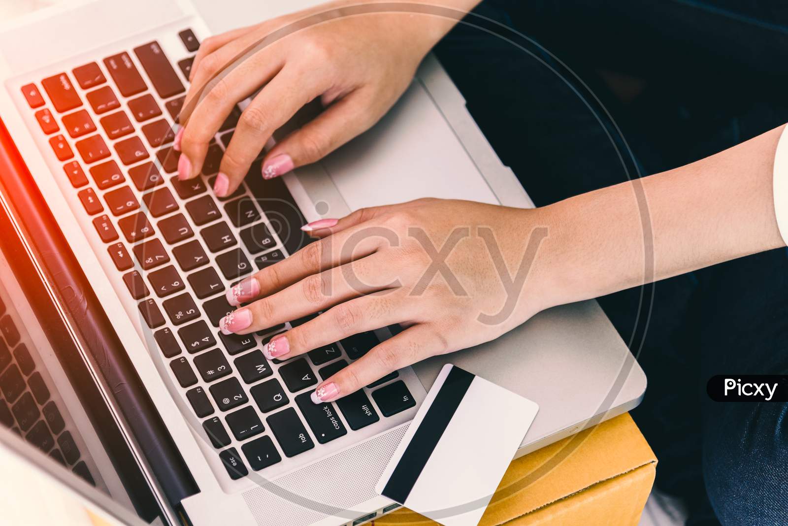 Close Up Of Woman Hands Using Laptop Computer With Credit Card Beside. Technology And Lifestyles Concept. Business Woman Theme.