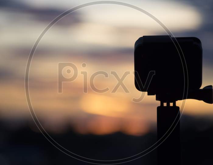Silhouette Action Camera In Front Of The Twilight Sky, Technology And Nature Concept