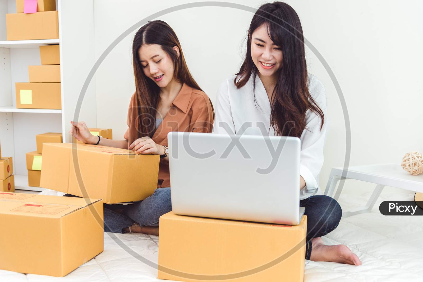 Young Asian Woman Startup Small Business Entrepreneur Sme Distribution Warehouse With Parcel Mail Box. Owner Home Office Concept. Online Marketing And Product Packaging And Delivery Service.