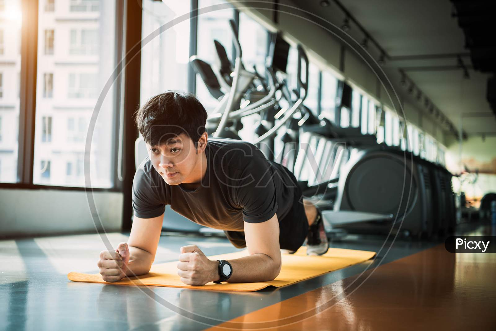 Portrait Of Asian Fitness Man Doing Planking Exercise In Gym. People Lifestyle And Sport Workouts Concept.