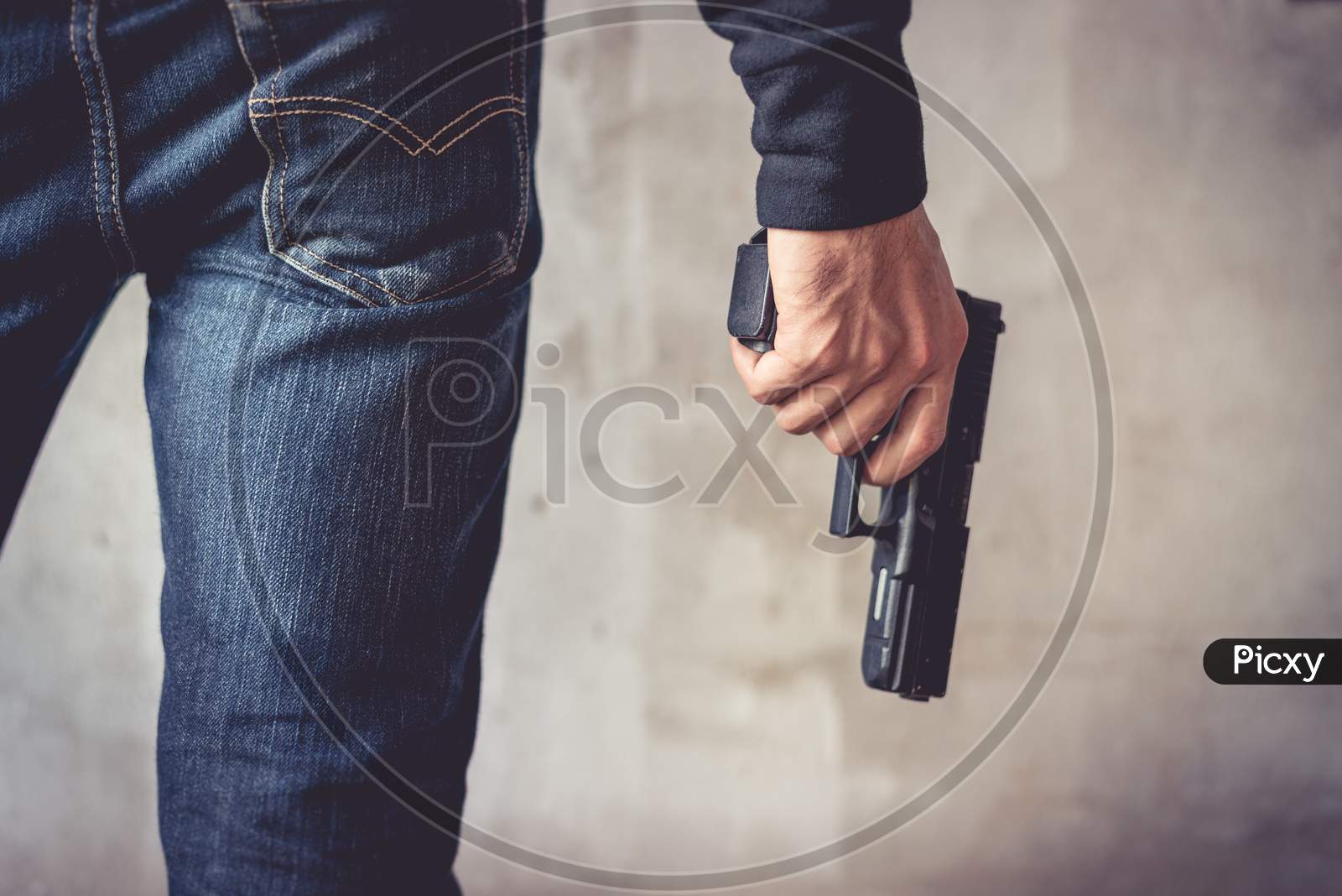 Close Up Of Man Holding Hand Gun. Man Wearing Blue Jeans. Terrorist And Robber Concept. Police And Soldier Concept. Weapon Theme