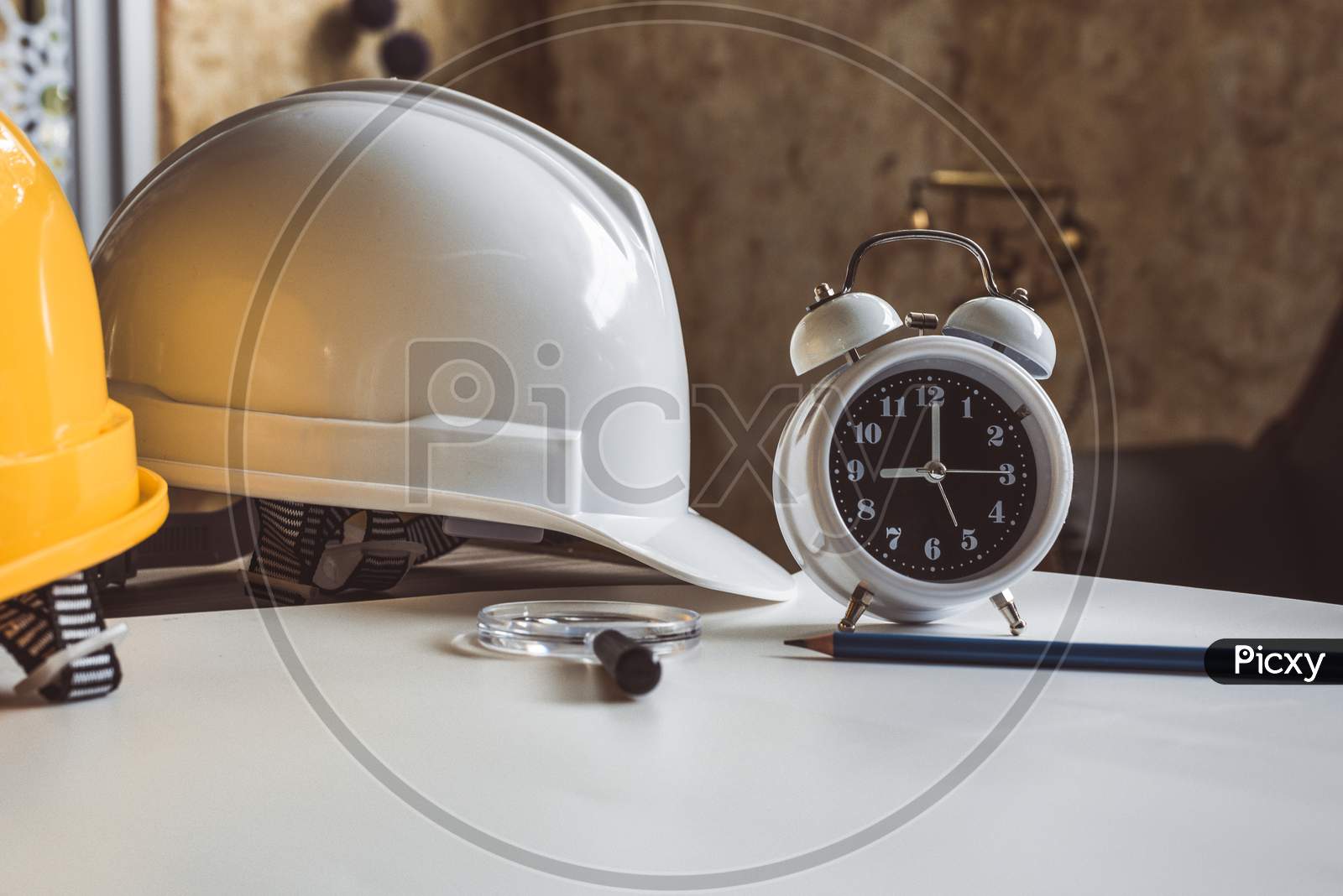 Close Up Of Clock And Engineering Safety Helmet On Blueprint Table. Architecture And Engineering Equipment Concept. Construction Site And Occupation Job Of Interior Building Professional Theme.