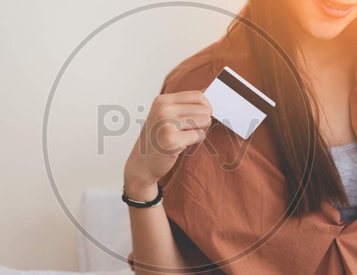 Young Happy Woman Using Credit Card. Business And Online Shopping Concept. Financial And Moneys Theme.