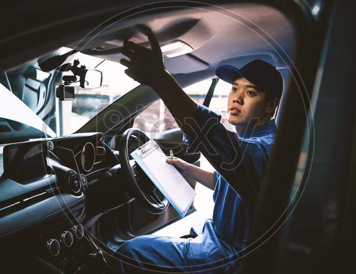 Mechanic Holding Clipboard And Checking Inside Car To Maintenance Vehicle By Customer Claim Order In Auto Repair Shop Garage. Repair Service. People Occupation And Business Job. Automobile Technician