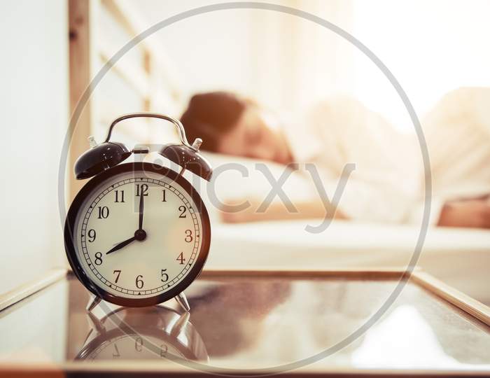 Alarm Clock With Beauty Woman In Background. Morning And Lazy Time Concept. Bedroom Theme.