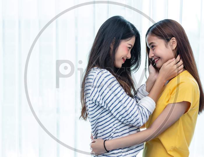 Two Asian Women Looking At Each Others In Home. People And Lifestyles Concept.  Lgbt Pride And Lesbian Theme.