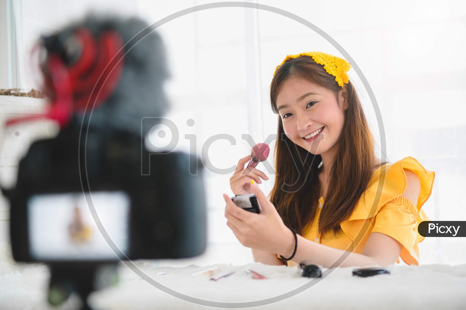 Happy Asian Young Beauty Blogger Girl Training How To Be Make Up Artist In Home Studio. Woman Speaking In Front Of Camera As Vlogger. Female Vlog Blogger Recording Video Tutorial Upload To Internet