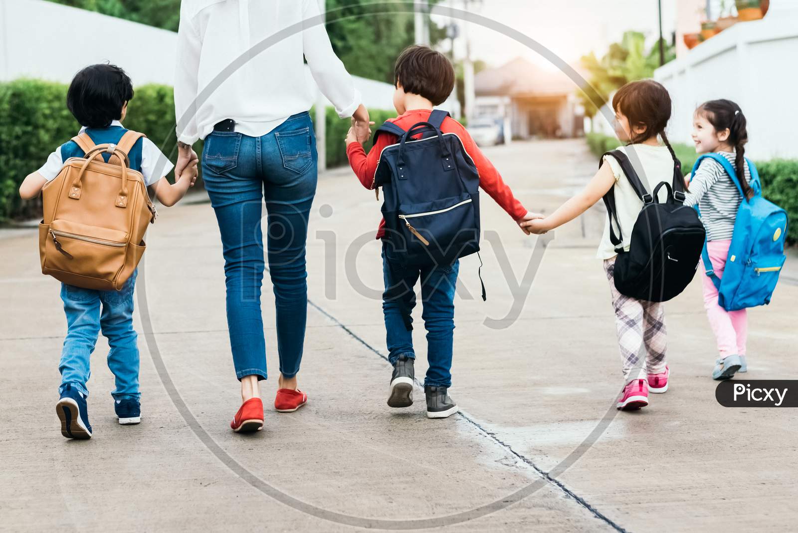 Back To School Students Mother Group Going School Together. Parent Send Little Boy And Girl For First Class Semester Term With Schoolbag Or Satchel Together. Collaborative Learning And Empathy Daycare