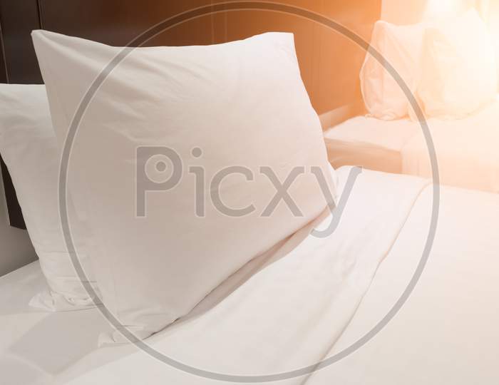 White Pillow In Bedroom. Home Decoration And Relaxation Concept. Object Theme. Orange Light Element