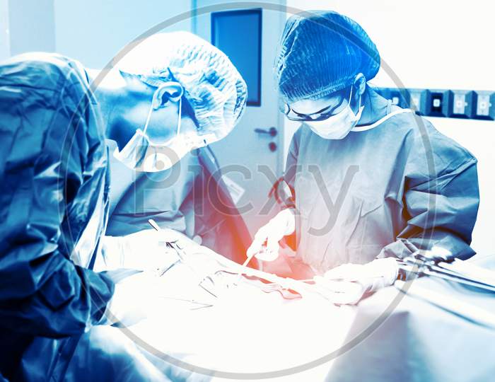 Doctor And Assistant Nurse Operating For Rescue Patient From Dangerous Emergency Case. Hospital And Surgery Concept. Health Care And Medical Concept. Cancer And Disease Treatment. Blue Tone Filter