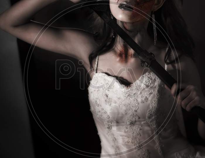 Zombie Lady Corpse Holding Sword To Kill Herself While Wedding. Horror And Ghost Concept For Halloween'S Day Theme Event. Dark And Grunge Tone Film