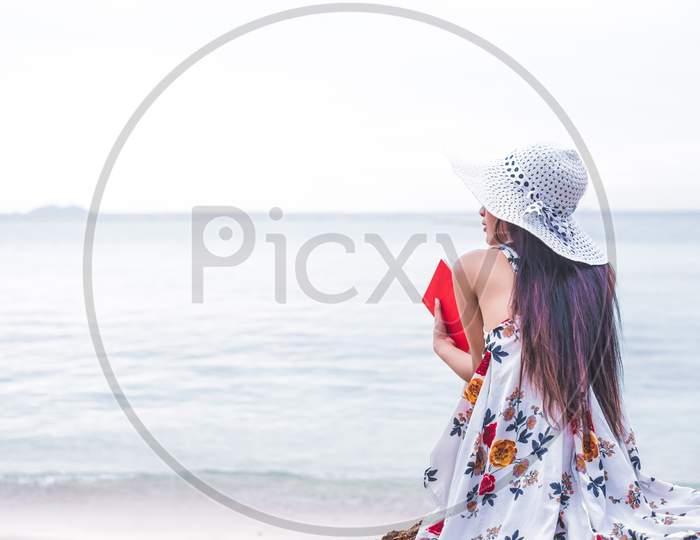 Asian Woman Waiting For Love Or Someone Make Her Happy. Lonely And Beauty Concept. Back View Scene Of Girl. Ocean And Sea Theme. Copy Space In Left Side. Woman Day And Soulmate Theme.