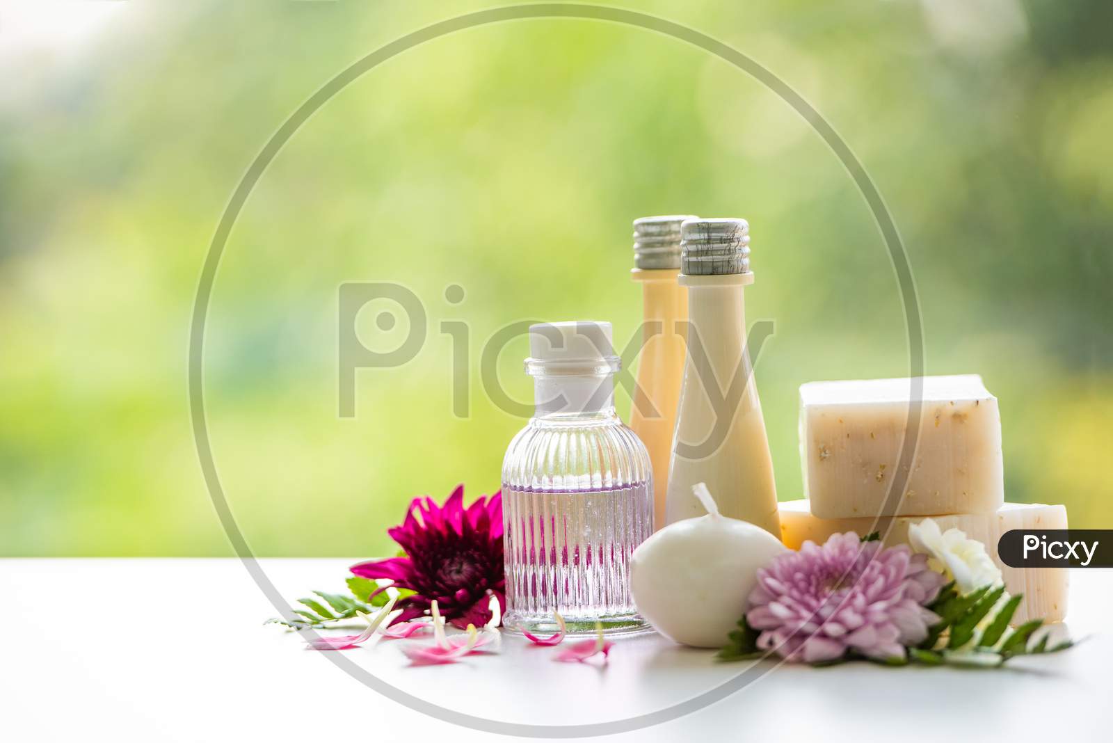 Floral Spa Treatments On White Wooden Table. Healthcare And Body Therapy Massage Relaxation Concept. Beauty And Healthy Theme. Pure Natural Extract And Medical Theme.