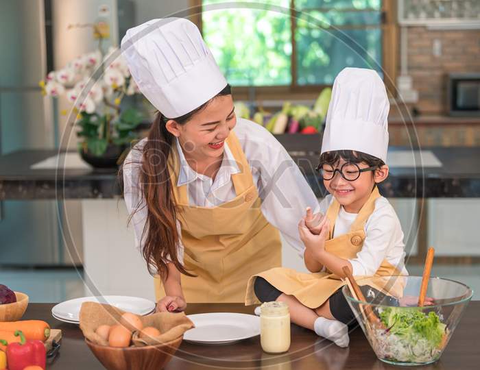 Happy Beautiful Asian Woman And Cute Little Boy With Eyeglasses Prepare To Cooking In Kitchen At Home Funny. People Lifestyles And Family. Homemade Food And Ingredients Concept. Two Thai People Life